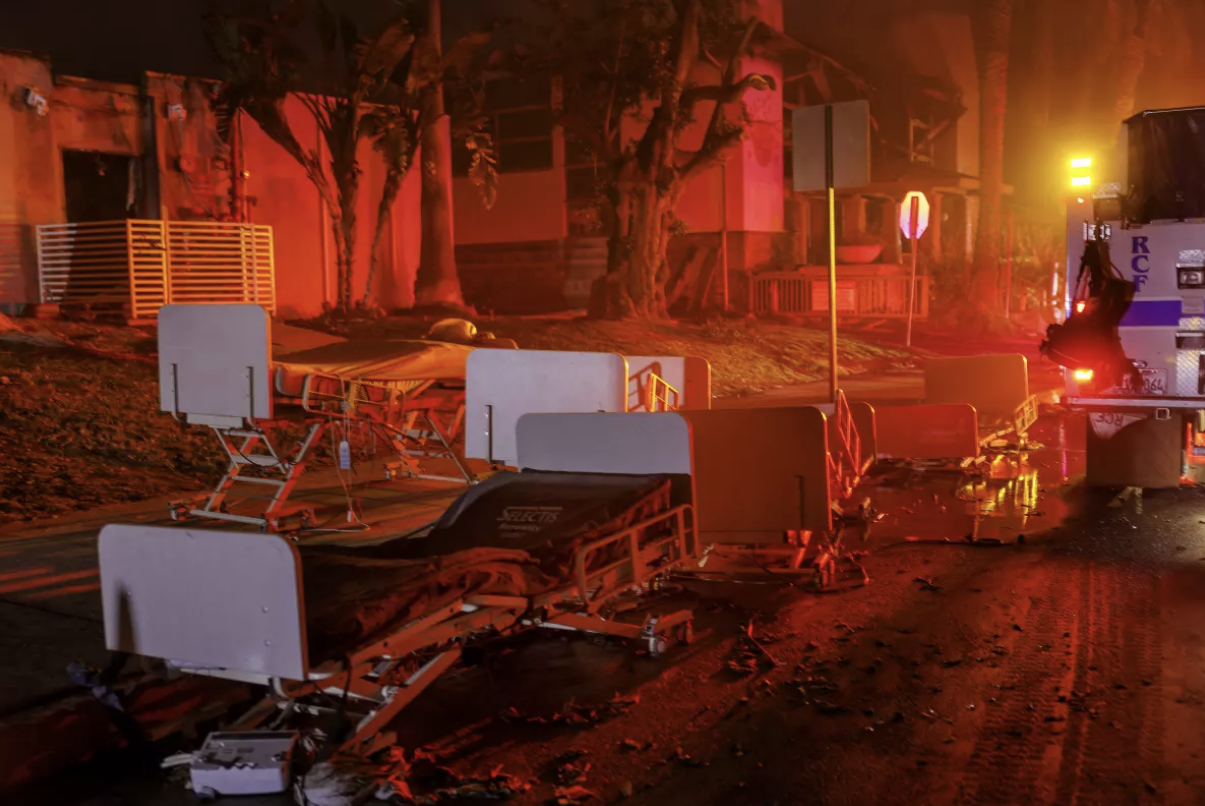 Hospital beds lay abandoned in the street after the evacuation of Two Palms Nursing Center during the Eaton fire in Altadena